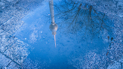 View of  berliner funkturm in puddle reflection 