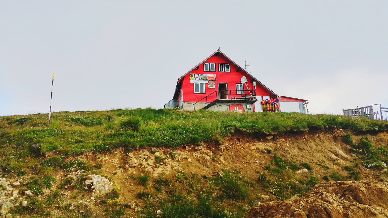 built structure, no people, architecture, day, field, clear sky, red, grass, outdoors, building exterior, tranquility, plant, nature, sky, landscape, growth, beauty in nature, tree