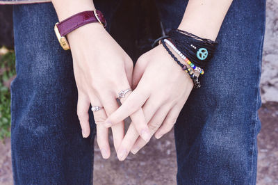 Midsection of woman wearing jewelry