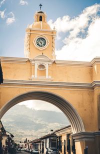 Low angle view of clock tower against sky in city