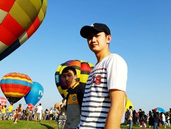 Full length of man with balloons against sky