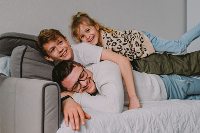 Kids playing with father at home