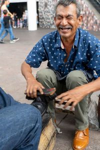 Portrait of woman sitting on street