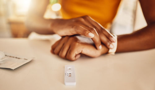 Midsection of woman drawing on table