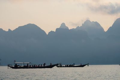 Scenic view of sea and mountains against sky