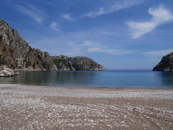 View of calm beach against blue sky