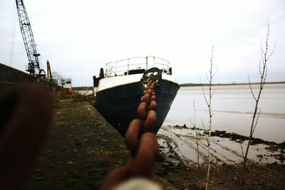 Close-up of person hand against clear sky