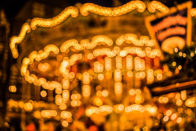 Low angle view of illuminated christmas lights at night