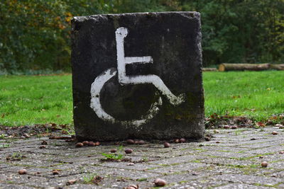 Close-up of sign on ground