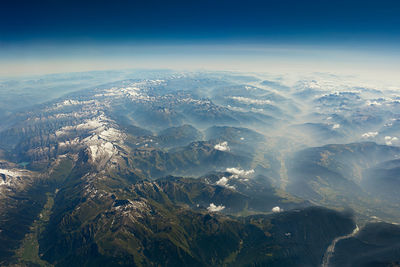 Aerial view of snowcapped mountains against sky