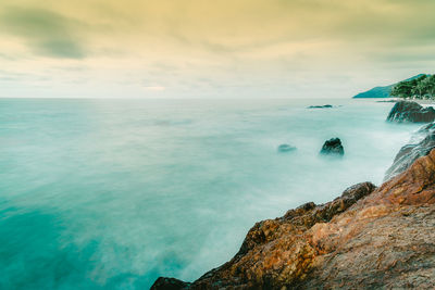 Scenic view of sea against cloudy sky