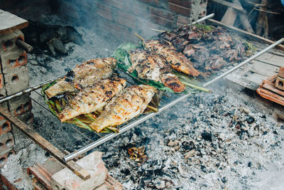 High angle view of meat on barbecue grill