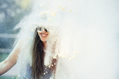 Powdered paint falling on happy woman