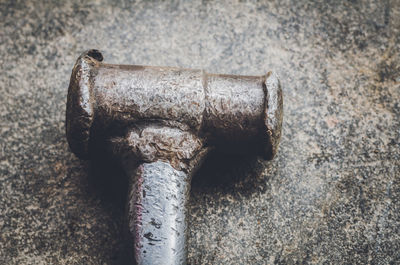 Close-up of hammer on footpath