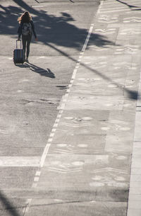 High angle view of woman walking on street