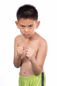 Portrait of shirtless boy standing against white background