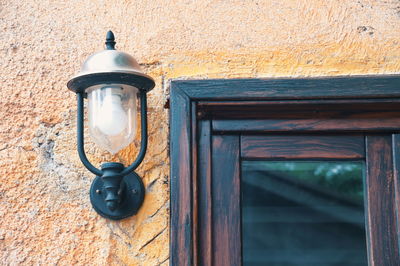 Rustic wall with lamp and part of window