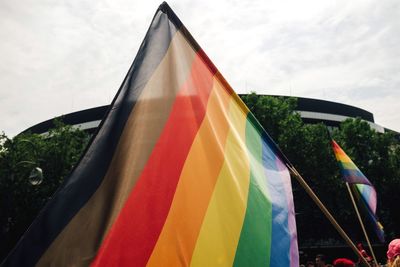 Close-up of multi colored flag against sky