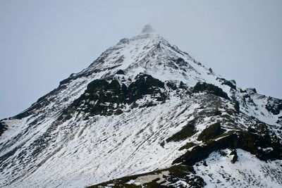 Scenic view of snowcapped mountains against clear sky
