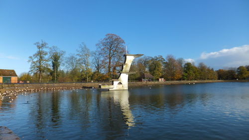 View of calm lake against blue sky