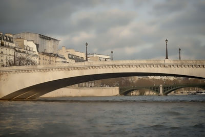 View of bridge over river against cloudy sky