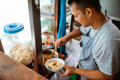 Midsection of man preparing food at home