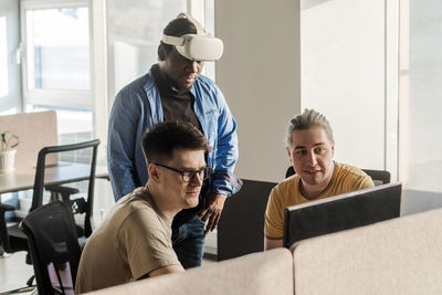 It development team working on vr project. black man wearing vr headset