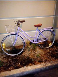 Bicycle parked against wall