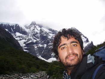 Portrait of smiling man against snowcapped mountains at torres del paine national park