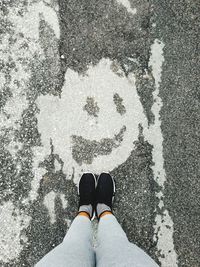 Low section of woman standing on street