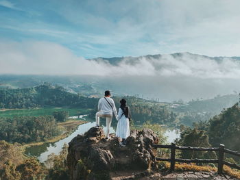 Rear view of couple looking at landscape