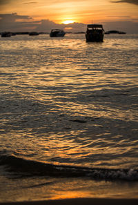 Scenic view of sea against orange sky