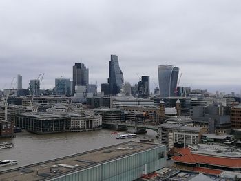 Cityscape against cloudy sky