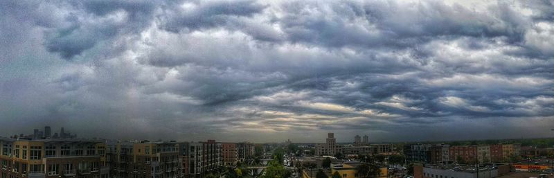 Cityscape against cloudy sky