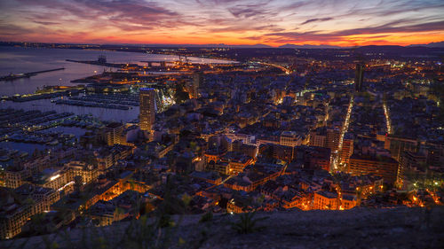 High angle view of illuminated buildings against sky during sunset