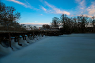 Bridge over river against blue sky
