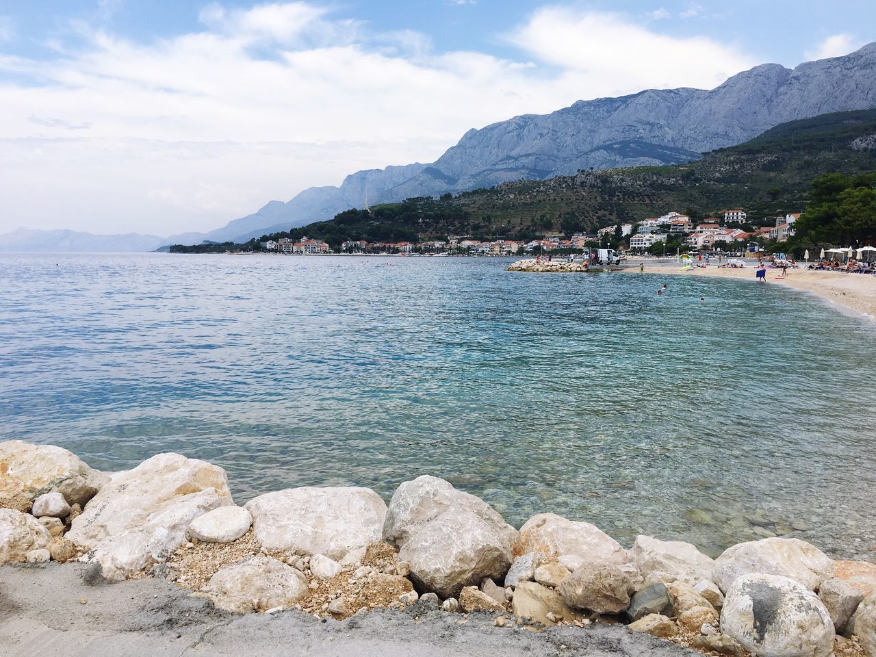 water, mountain, sky, sea, scenics, tranquil scene, tranquility, beauty in nature, nature, mountain range, shore, cloud - sky, coastline, cloud, idyllic, day, outdoors, vacations, blue, tourism, rippled, non-urban scene, travel destinations, remote