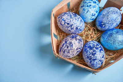 High angle view of blue eggs on white background