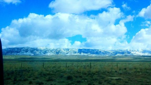 Scenic view of landscape against cloudy sky