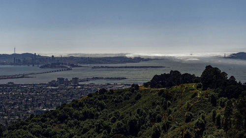 High angle view of buildings and sea against sky