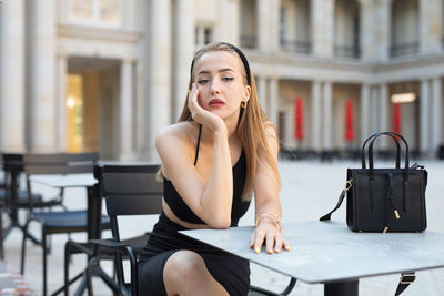 Young woman using mobile phone in cafe