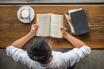 Directly above shot of woman holding coffee cup