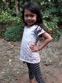 Portrait of a girl standing on field