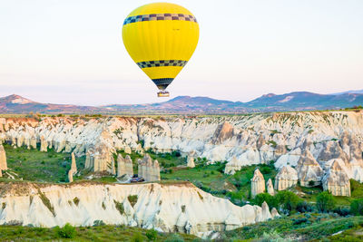 Hot air balloon over cappadocia against sky