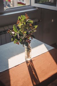 Close-up of flower vase on table at home