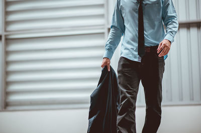 Midsection of man standing at home