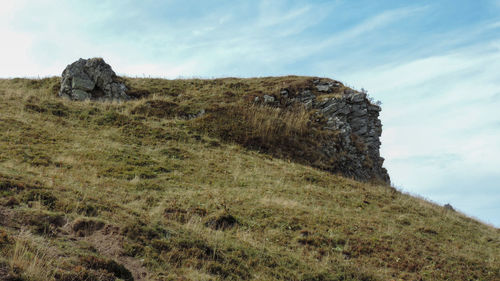 Scenic view of rocks on field against sky