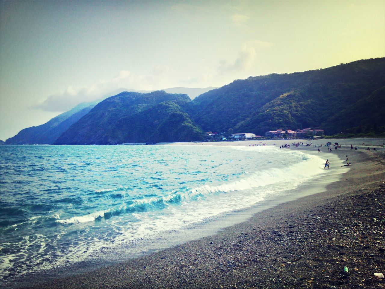 mountain, beach, water, sea, scenics, sky, tranquil scene, sand, beauty in nature, shore, tranquility, mountain range, nature, coastline, cloud - sky, incidental people, idyllic, vacations, non-urban scene, cloud