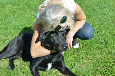 Woman with dog on field