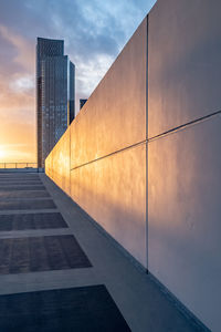 Low angle view of modern building against sky during sunset